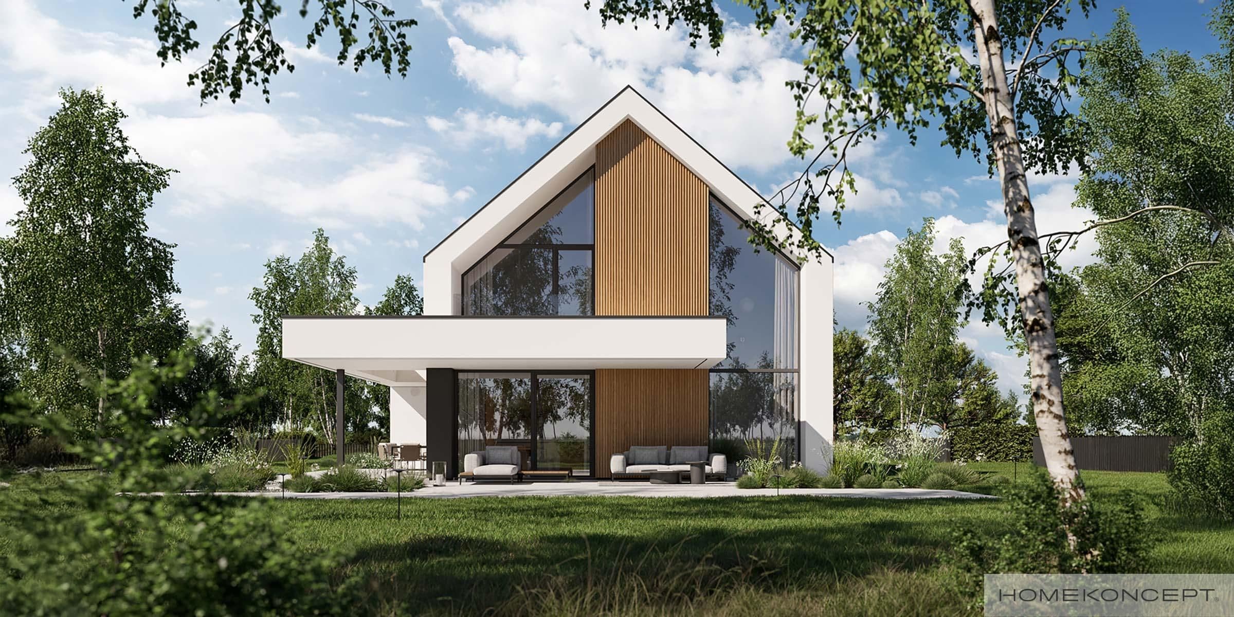 Modern A-frame house with large glass windows and wood accents in a natural setting.